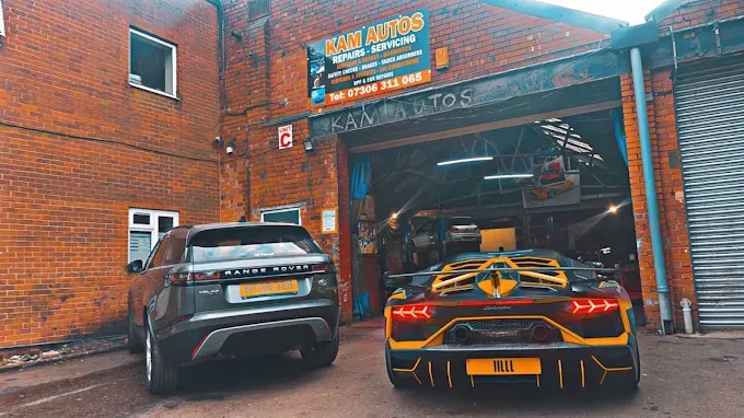 Kam Autos garage exterior on Pear Tree Road, Derby, with cars parked outside the workshop