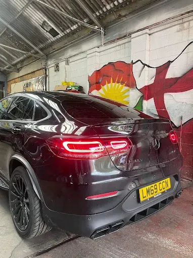 Black Mercedes inside the Kam Autos workshop in Derby